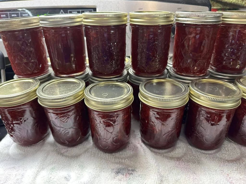 Strawberry jam recipe without pectin cooling in a jar with fresh strawberries